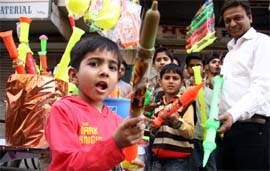 A child flaunts a squirt gun on the eve of Holi in Bathinda on Sunday