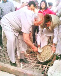 Assembly Speaker Harbans Kapoor lays the foundation stone of a nullah in Dehradun