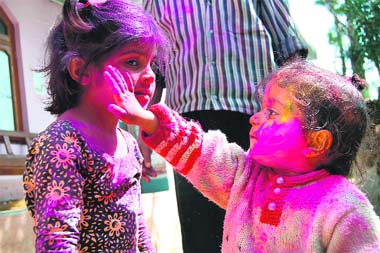 Children play Holi at Sakoh village near Dharamsala on Sunday.