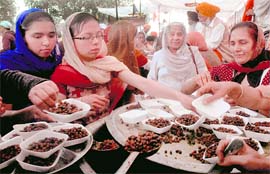 Devotees take prasad at a langar on the Kiratpur Sahib-Anandpur Sahib road on Hola Mohalla on Sunday
