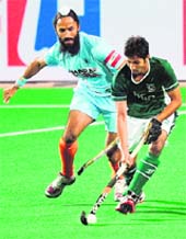 Indian captain Rajpal Singh (L) vies for the ball with Pakistans Abdul Haseem Khan during their World Cup match at the Major Dhyan Chand Stadium in New Delhi on Sunday.