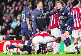 Arsenals Aaron Ramsey lies injured during their game against Stoke City on Saturday.