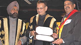 A P Pandey, DGP (Vigilance), PSEB, gets his PhD degree from Shivraj Patil, Punjab Governor and Chancellor of Guru Nanak Dev University, during the annual convocation of the university in Amritsar.
