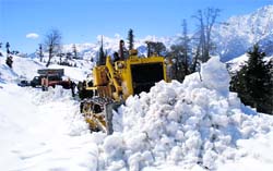 Snow-clearing in full swing near Gulaba, about 16 km from Manali, on the Manali-Rohtang road on Tuesday.