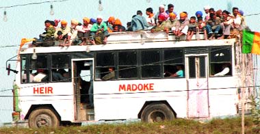 A private bus carries people on its top in violation of rules in Jalandhar.
