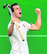 England's Nick Catlin reacts after scoring a goal against South Africa at the Major Dhyan Chand Stadium in New Delhi on Tuesday.