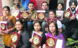 Students are all smiles after receiving prizes at a function in Panjab University in Chandigarh on Wednesday.