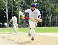 Batsmen run between the wickets at the Jatinder Singh Anand (Kaka) Memorial Cricket Tournament in Dehradun on Wednesday