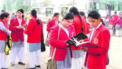 Students make a last-minute revision before entering the examination centre in Ludhiana