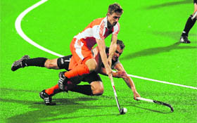 New Zealands Blair Hopping tries to stop Netherlands Phillip Burrows during their World Cup 2010 match at the Major Dhyan Chand Stadium in New Delhi on Wednesday.