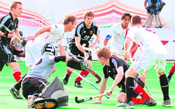 Players of Germany and Canada vie for the ball during their match for the Hero Honda Hockey World Cup in New Delhi on Wednesday.