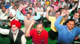 UT employees raise slogans during a joint convention at the Sector 21 community centre in Chandigarh on Thursday