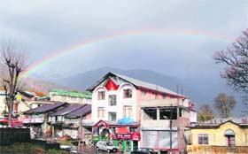 Rainbow, following a drizzle, brightens the sky at Dharamsala