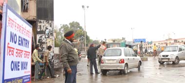 Policemen regulate traffic near the railway station in Jalandhar