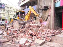 A JCB machine demolishes illegal structures outside Union Bank of India/Nikka Mal showroom on the Mall road in Ludhiana on Thursday. 