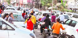 Parents and guardians wait to pick their wards from school after the exam that led to traffic chaos in Ludhiana on Thursday.