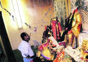 A man looks at broken statues inside a temple damaged by a quake of 6.4 magnitude that hit Shanlin township in southern Taiwan