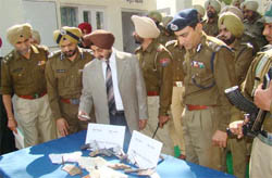 Punjab DGP Paramdeep Singh Gill inspecting the arms seized in Mansa 