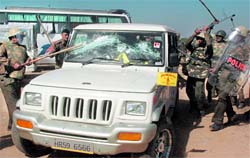 Policemen smash the windowpanes of a vehicle in Chandigarh on Friday
