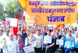 Memebers of various trade unions hold a protest in Sector 22, Chandigarh, on Friday