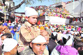 Devotees at the Jhanda Mela in Dehradun on Friday. 