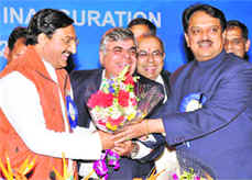 Uttarakhand Chief Minister Ramesh Pokhriyal Nishank presents a bouquet to Union Heavy Industries and PSU Minister Vilasrao Deshmukh at Pantnagar on Friday.