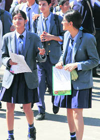 Students come out of a centre after appearing in the examination in Jammu on Friday.