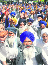 Activists of farmers unions from Punjab and Haryana take to sloganeering to protest price rise in New Delhi on Friday.