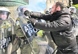 Demonstrators clash with the riot police during a protest outside the Greek Parliament in Athens on Friday.