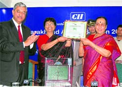 Uttarakhand Governor Margaret Alva gives CII Green Building award to Harshwanti Bisht at a function in Dehradun on Saturday