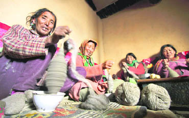 Womenfolk spin yarn in a village in Lahaul and Spiti 	