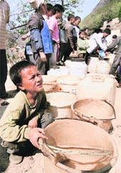 Villagers wait to collect water provided by the local government in the drought-hit Guangnan county of Yunnan province in China. The province has been facing water shortage due to a prevailing drought. 