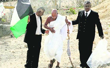 From left to right, demonstrators disguised as former South African President Nelson Mandela, Mahatma Gandhi and Martin Luther King, Jr, at a protest against Israels separation barrier in the West Bank village of Bilin, near Ramallah. Israel says the barrier is needed for security, but Palestinians consider it a land grab.