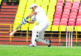A batsman plays a cover drive during a cricket match on Sunday.