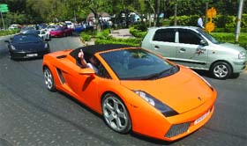 A partcipant waves during the Parx Super Car Show 2010 in New Delhi on Sunday.