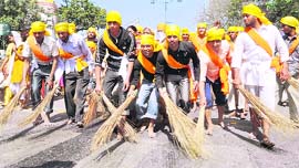 Devotees sweep the roads before the start of the parikarma.