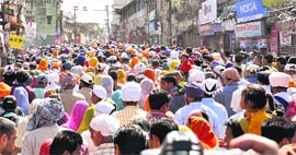 Devotees throng the streets of Dehradun on Sunday.
