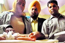 Abandoned baby girl, who was saved by a couple (in pic) at a hospital in Ludhiana on Sunday