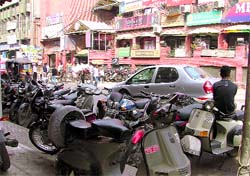 Vehicles parked haphazardly in front of the AC Market near Bhadaur House