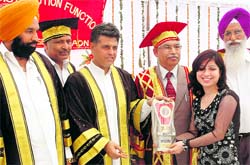 Member of Parliament Manish Tewari gives a prize to a students at LR DAV College, Jagraon, on Sunday