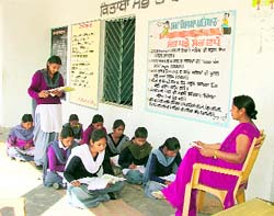 Students of Government Elementary School study in the corridor in the absence of classrooms in Salempur