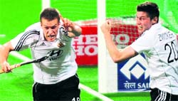 Germanys Oliver Korn (L) celebrates a goal against Netherland in New Delhi on Sunday