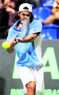 Indias Somdev Devvarman returns a service to Russian Mikhail Youzhny on Sunday