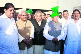 Legislators of the INLD with their leader Om Prakash Chautala outside the assembly after their suspension