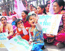 Activists of the All-India Democratic Womens Association shout slogans in support of the Womens Reservation Bill on the International Womens Day at Shimla on Monday.