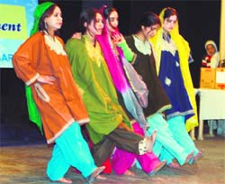 College girls dance at a function organised by the CRPF at Tagore Hall in Srinagar on Monday.