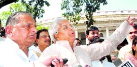 RJD president Lalu Prasad Yadav and Samajwadi Party chief Mulayam Singh Yadav outside Parliament on Monday.