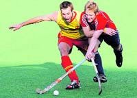Spains David Alegre (L) fights for the ball with Englands Ashley Jackson in New Delhi on Monday