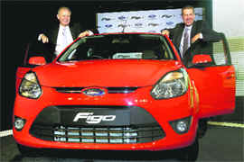 Ford India MD Michael Boneham and vice-president Joe Hinrichs (R) pose with new model of Figo car at its launch in New Delhi on Tuesday.