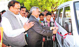 Sundar Lal, Group General Manager, Employees Relations and Head Corporate Administration, presents a mobile van to Gokul, an NGO for the disabled in Dehradun on Tuesday.